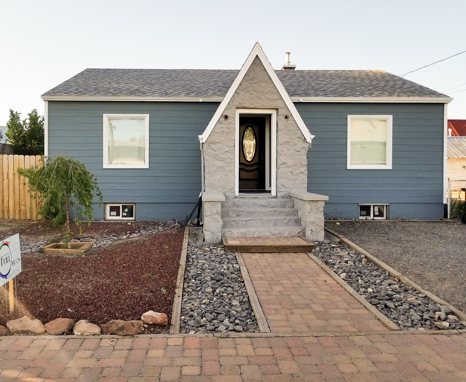 Finished exterior repaint, single-story blue-gray craftsman cottage with a stone entry gable